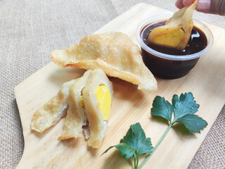 A Serving Of Golden Pempek Kapal Selam On A Wooden Board