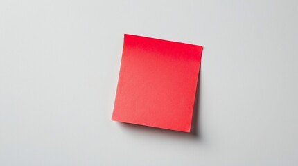 Single Bright Red Sticky Note Adhering to a Plain White Background.
