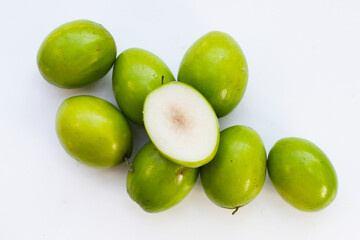 Green jujube fruits on white background.