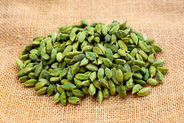 Green cardamom pods with aromatic and medicinal benefits.