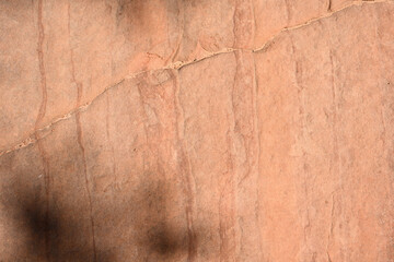 Closeup of orange red sandstone rock with vertical and diagonal line patterns and texture, as a nature background, Zion National Park, Utah
