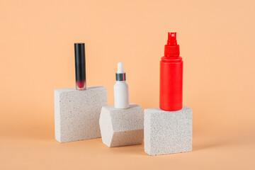 Cosmetic pink bottle. Womens cosmetic accessory for makeup with stylish props on cream background.