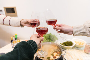 Clinking Red Wine Glasses At Festive Gathering