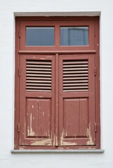 Shuttered window view urban setting architectural detail textured environment photography perspective vintage concept