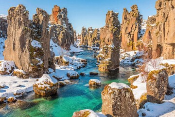 Icy canyon with turquoise river, dramatic rock formations