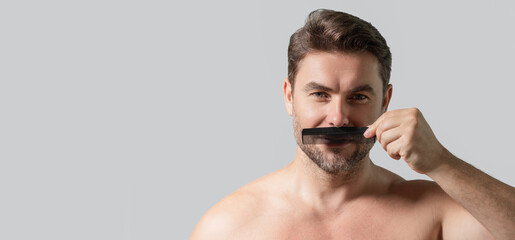 Fototapeta premium Man with scissors. Man cut hair with hairdressing scissors. Men haircut in studio. Barber scissors. Mens cut beard hair. Guy holding scissors. Banner for header, copy space. Poster for web design.