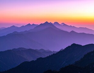 Fototapeta premium Majestic Mountain Range Layers Under Vibrant Sunset Sky with Purple and Orange Hues and Detailed Peaks in a Wide Angle Landscape