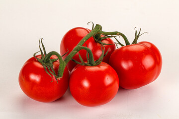 Ripe fresh tomato on the branch