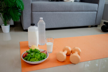 A joyful child and woman indoors holding glasses of milk, smiling happily, symbolizing health, freshness, nourishment, and a positive lifestyle.
