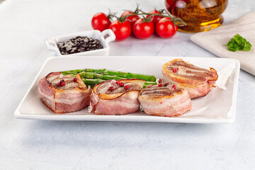 Tasty grilled pork medallion with bacon