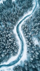 Aerial view of serene river in snow-covered forest during winter