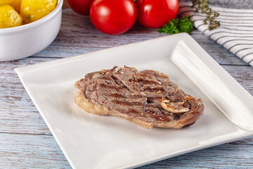 Grilled lamb steak with bone