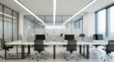 Modern blurred office interior with desks, chairs, and computers. Bright daylight through large glass windows creates a clean, minimal, and professional work environment with a soft focus aesthetic.