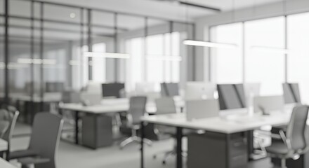 Modern blurred office interior with desks, chairs, and computers. Bright daylight through large glass windows creates a clean, minimal, and professional work environment with a soft focus aesthetic.