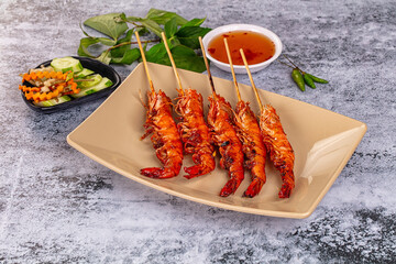 Grilled prawn skewer served sauce