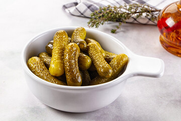 Marinated canned green cornichon cucumbers