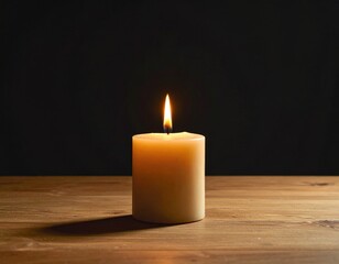 A softly lit candle, creamy-white, rests on a wooden surface, flame dancing against a blurred, dark backdrop, emitting warm, inviting light