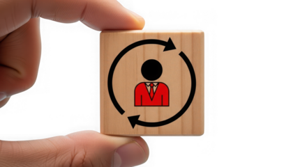 Hand holding a wooden block with a person icon and circular arrows, symbolizing employee rotation or change, isolated on transparent background