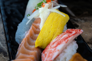 various nigiri on the black dish © 안구정화