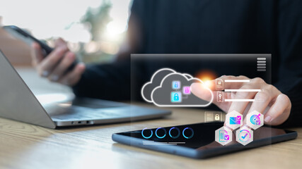 Hand using tablet with cloud storage and security lock icons, data protection, cybersecurity, online safety, and cloud computing technology for secure digital business solutions.