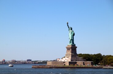 Fototapeta premium view from the sea of the iconic Statue of Liberty symbol of New York and also of democracy and universal freedom