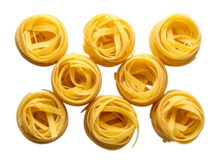 Raw tagliatelle pasta nests arranged neatly in a circular pattern, highlighting their golden color and smooth, uncooked texture on white background.