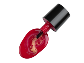 Red nail polish with swirl design, spilled and glistening on white surface, highlighting golden shimmer and glossy beauty product texture.