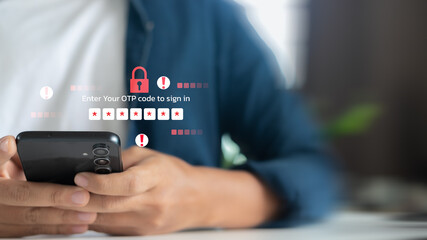 Person holding smartphone with OTP code entry warning, concept of phishing, online fraud, and cybersecurity threats © K2LStudio