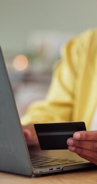 Hands, person and laptop with credit card for online shopping, typing password or checkout discount code. Internet banking, shopper and easy payment with fintech, ecommerce and account info at home
