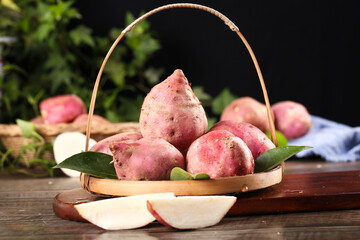Fresh Sweet Potatoes in Wicker Basket on Rustic Wooden Table - Healthy Organic Root Vegetables