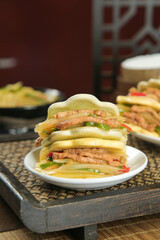 Handmade Asian Steamed Buns with Colorful Vegetable Filling and Meat on White Plate
