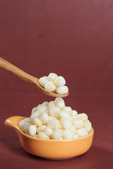 Fresh White Corn Kernels in Bowl with Wooden Spoon - Healthy Breakfast Cereal Ingredient