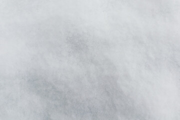 Fototapeta premium A detailed view of freshly fallen snow, showing its soft, textured surface in shades of white and light gray.
