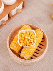 Fresh Sweet Corn Cobs and Kernels in Bamboo Steamer Basket - Golden Yellow Organic Vegetables for Healthy Cooking