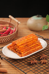 Spicy Orange Handmade Noodle Sticks Traditional Asian Snack Food on Wooden Table