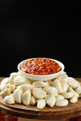 Garlic Cloves with Hot Chili Sauce for Asian Cooking on Wooden Board