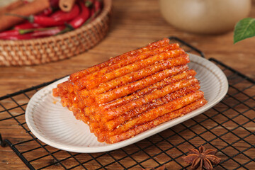 Spicy Dried Meat Sticks Traditional Asian Snack Food on Wooden Background with Chili Peppers