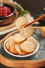 Traditional Chinese Chicken Sausage Rounds Served with Chopsticks in Bamboo Steamer - Asian Cuisine Hospitality