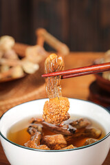 Dried Agaricus Blazei Mushroom with Chopsticks in Traditional Medicinal Soup Bowl