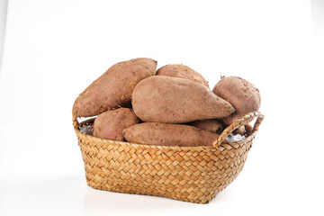 Sweet Potatoes in Wicker Basket on White Background
