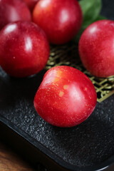Fresh Australian Red Plums Display on Slate Board - Imported Stone Fruit with Glossy Jeweled Skin