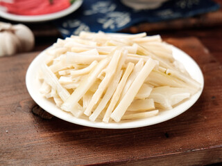 Shredded bamboo shoots on plate - fresh Asian vegetable ingredient for traditional cooking