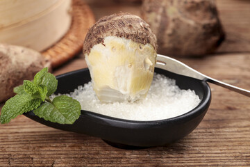 Taro Ice Cream with Coconut Flakes and Fresh Mint on Rustic Wooden Background