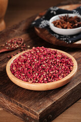 Red Sichuan Hanyuan Pepper Kernels Dahongpao Spice in Wooden Bowl on Rustic Kitchen Table