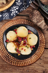 Fresh Shandong taro root slices with cranberries and nuts traditional Chinese cuisine on rustic wooden table