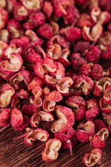 Dried Red Sichuan Peppercorns on Wood Background - Chinese Spice Ingredient Close-up