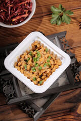 Japanese Natto Fermented Soy Beans with Green Onions in White Container on Wooden Background