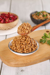 Japanese Natto Fermented Soybeans on Wooden Spoon - Traditional Healthy Protein Food with Sticky Texture