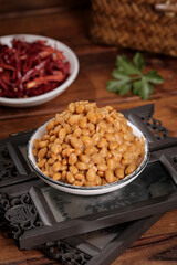 Japanese Natto Fermented Soybeans in Small Bowl with Mixed Traditional Dishes on Wooden Table