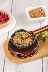 Traditional Japanese Natto Fermented Soy Beans in Stone Bowl with Chopsticks